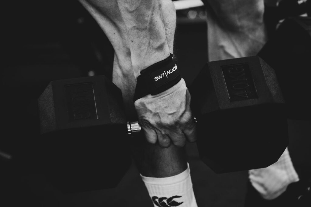 close up of individual, carrying a 40kg dumbbell.