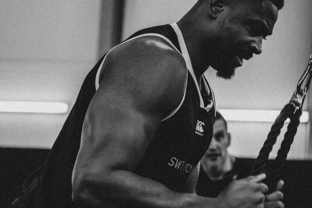 Person using cables in the gym.